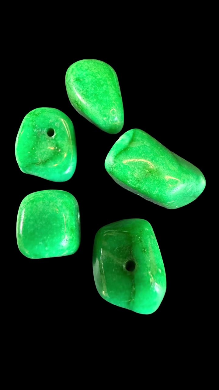 Tumbled green gemstones, possibly Aventurine or Chrysoprase